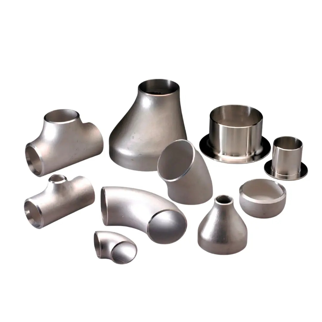 Variety of stainless steel pipe fittings including elbows, tees, reducers, and caps displayed on a white surface.