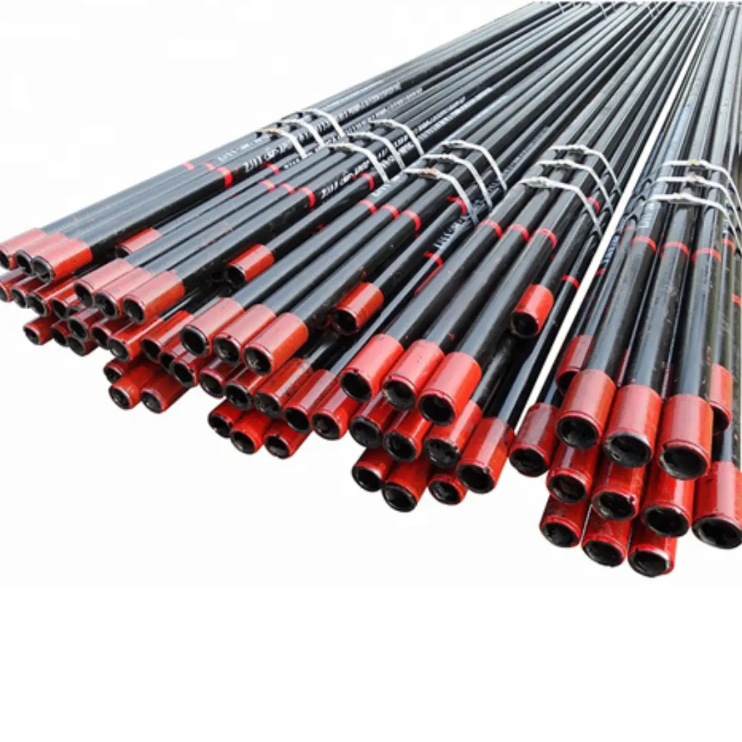 Large bundle of black metal pipes with red threaded ends, stacked and secured with straps for industrial use.
